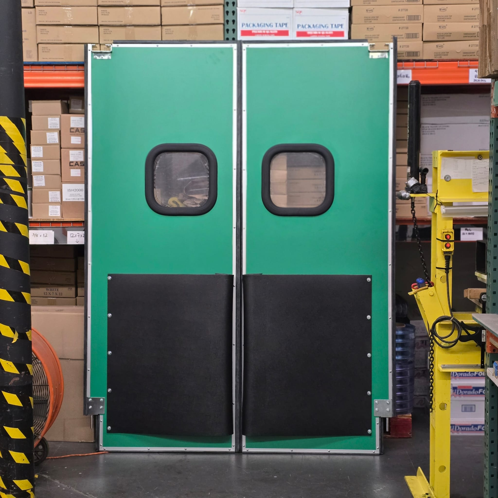 Green double doors with viewing windows